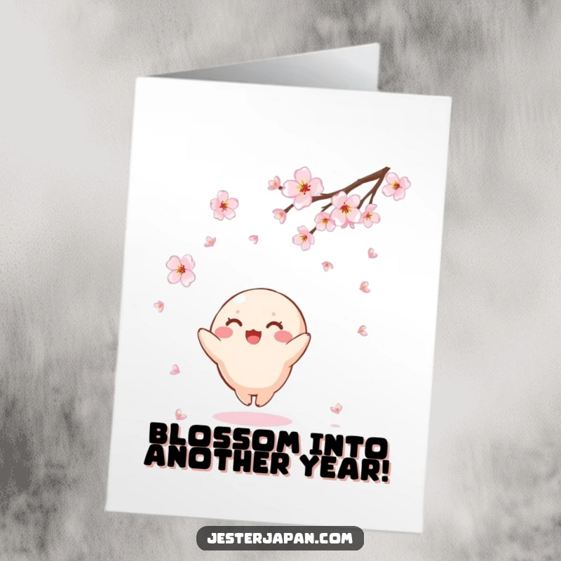 Funny Free Printable Birthday Card featuring a small, round Kawaii character joyfully reaching up to catch falling cherry blossoms.